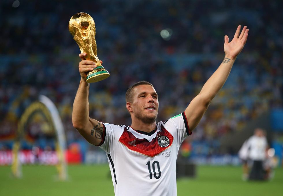 13 July 2014, Lukas Podolski of Germany celebrates with the World Cup trophy after defeating Argentina 1-0 in extra time during the 2014 FIFA World Cup Brazil Final match between Germany and Argentina at Maracana in Rio de Janeiro.