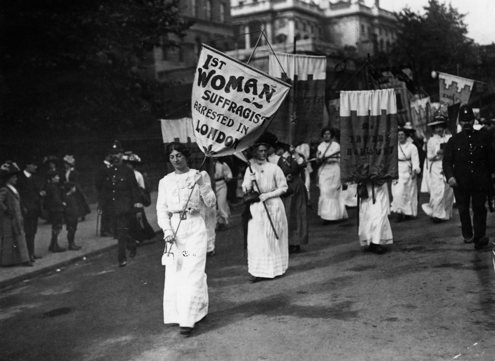1913: A protest march by women suffragettes in London with police in attendance. 