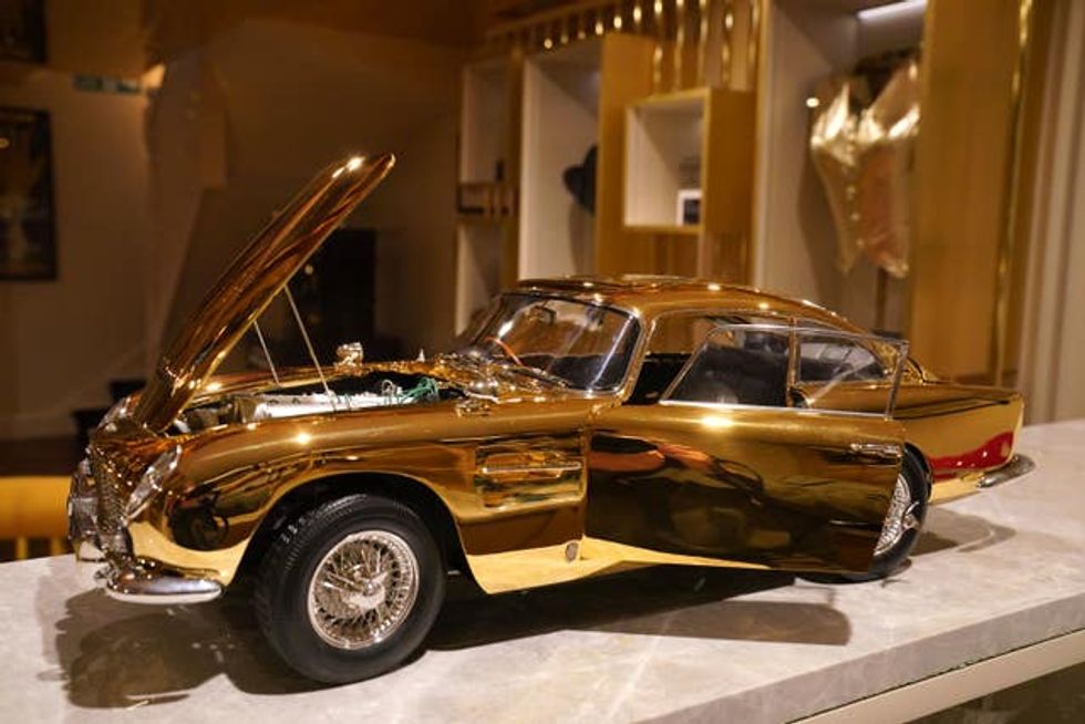 24-carat model of James Bond\u2019s Goldfinger Aston Martin DB5 on display with its doors and bonnet open