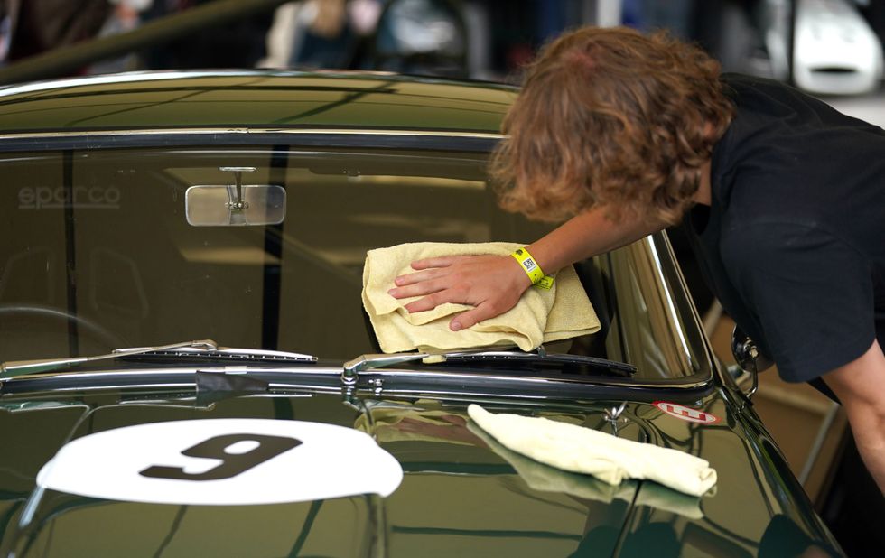 A 1960 Aston Martin DB4GT is spruced up (Andrew Matthews/PA)