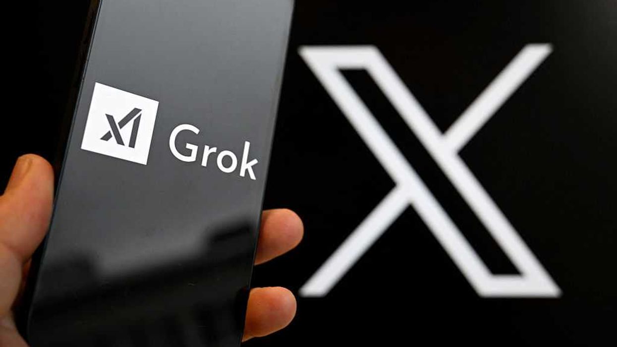 A black iPhone shows the text 'Grok' on the left. In the background, slightly out of focus, is the 'X' logo.