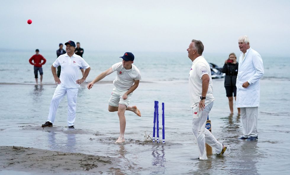 A bowler releases the ball after a soggy run-up (Andrew Matthews/PA)