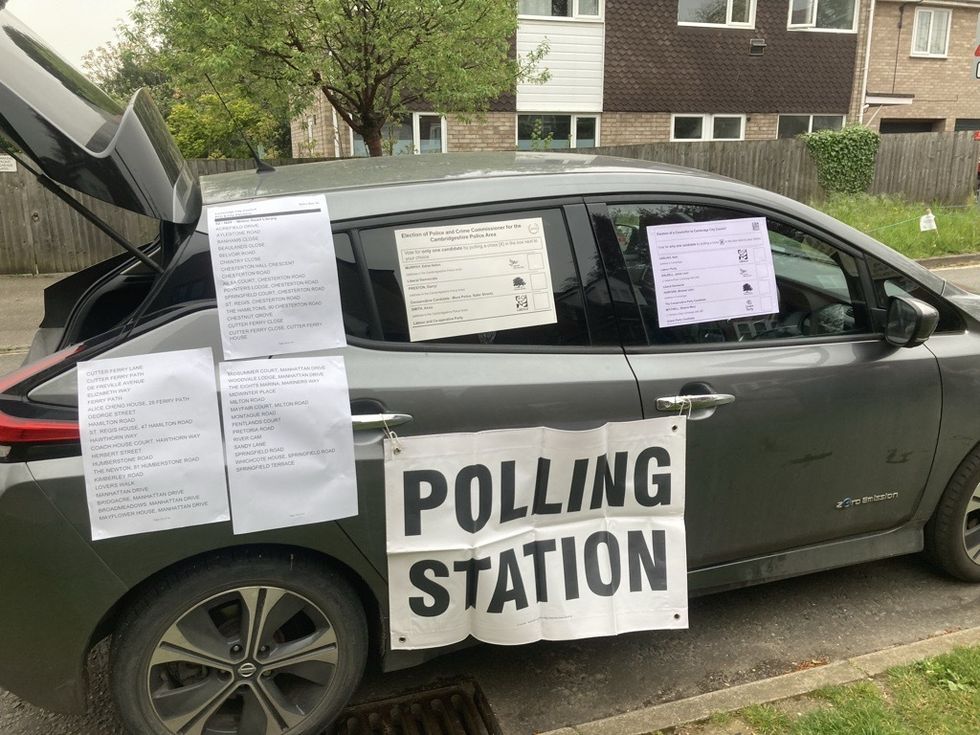 Voters cast ballots from back of car as usual polling station was shut