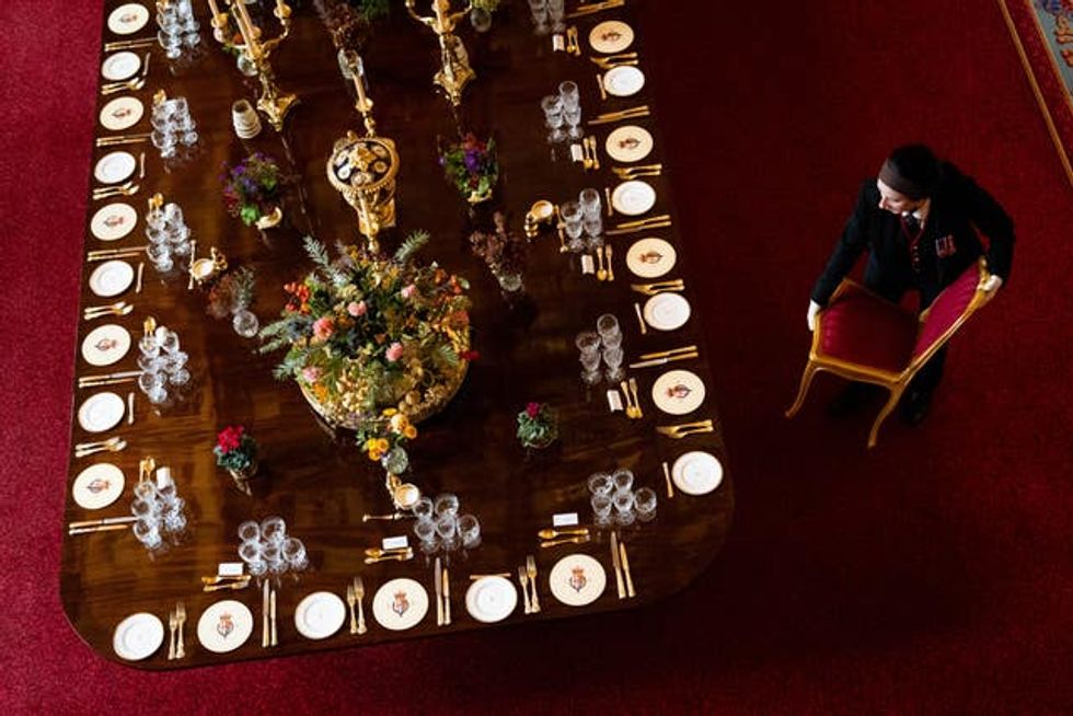 A chair is moved into position at the banquet table