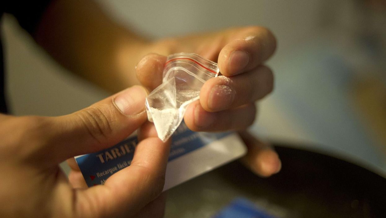 A Colombian drug dealer prepares cocaine for street sale in Bogota, on 20 September 2013