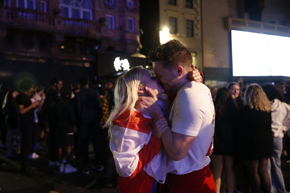 A couple share a kiss after England beat Ukraine