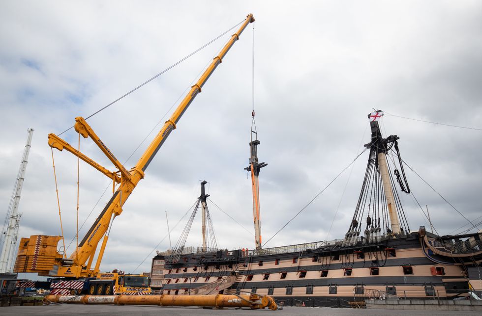 A crane begins the process of removing the main lower mast from HMS Victory at Portsmouth Historic Dockyard (Andrew Matthews/PA)
