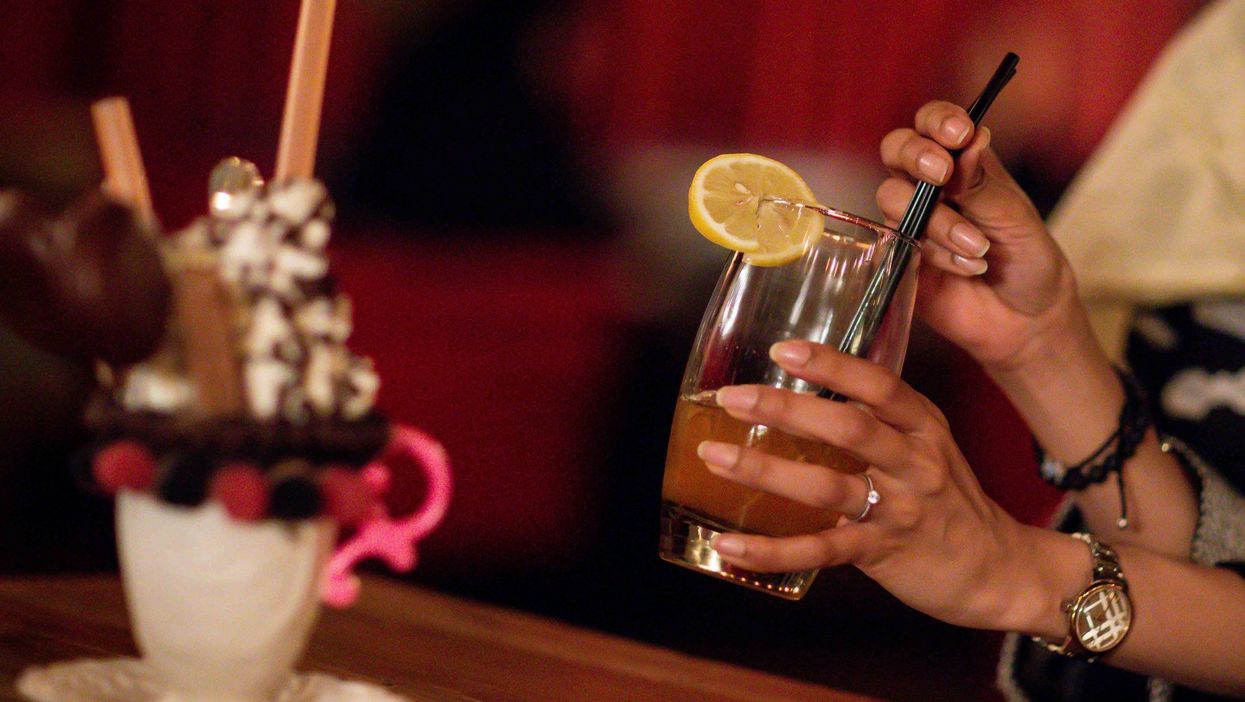 <p>A customer drinks a non-alcoholic drink in a cafe in Riyadh</p>