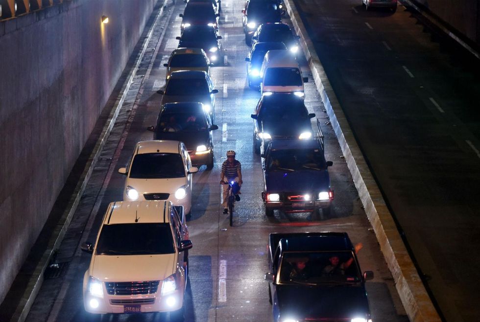 A cyclist is seen riding along one of the main streets of San Salvador on October 7, 2015
