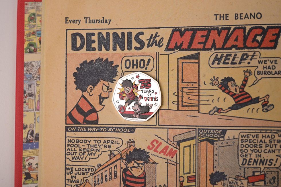A Dennis the Menace 50p coin placed on a copy of The Beano