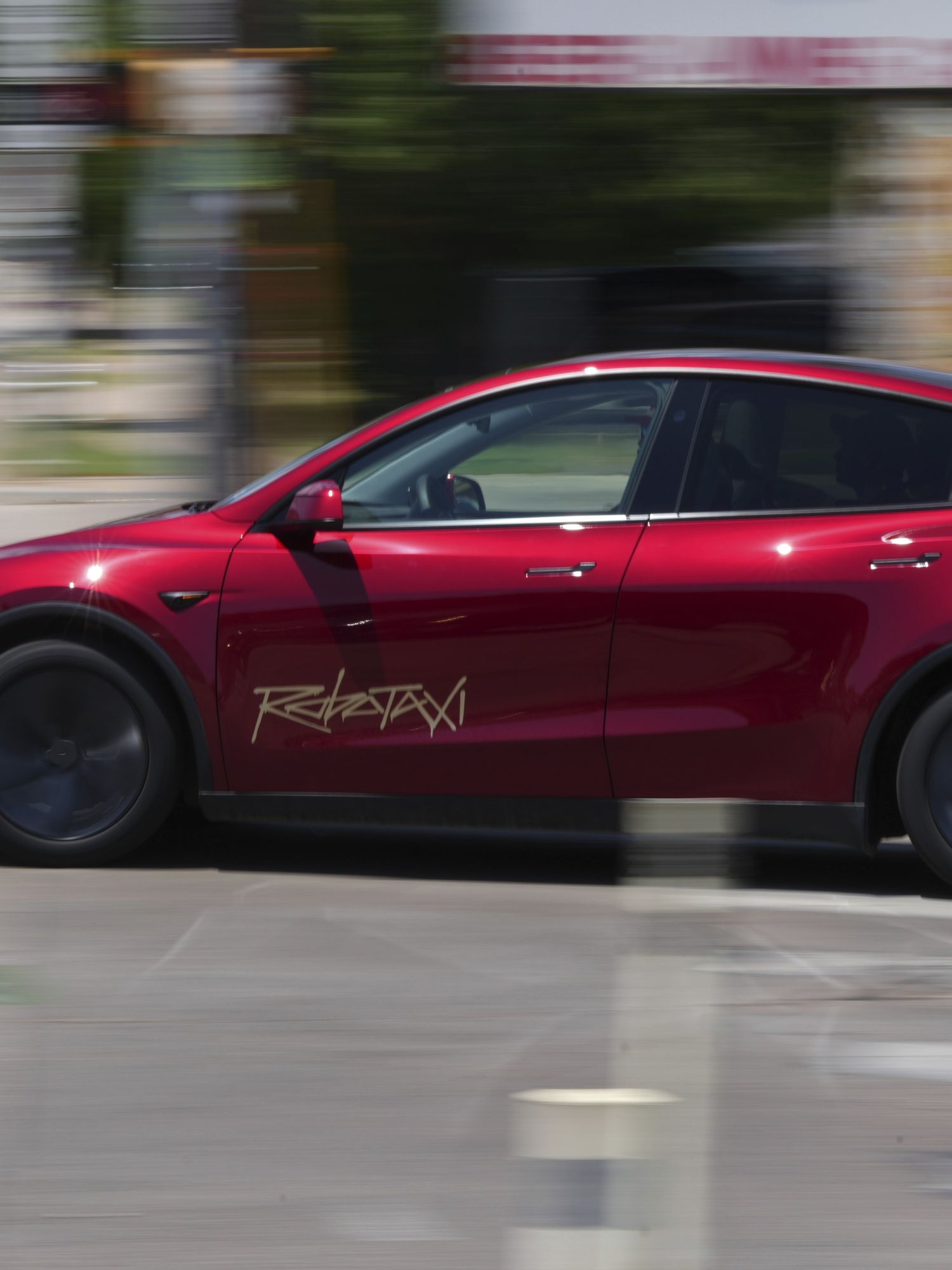 A driverless Tesla robotaxi, a ride-booking service, moves through traffic, Sunday, June 22, 2025, in Austin, Texas