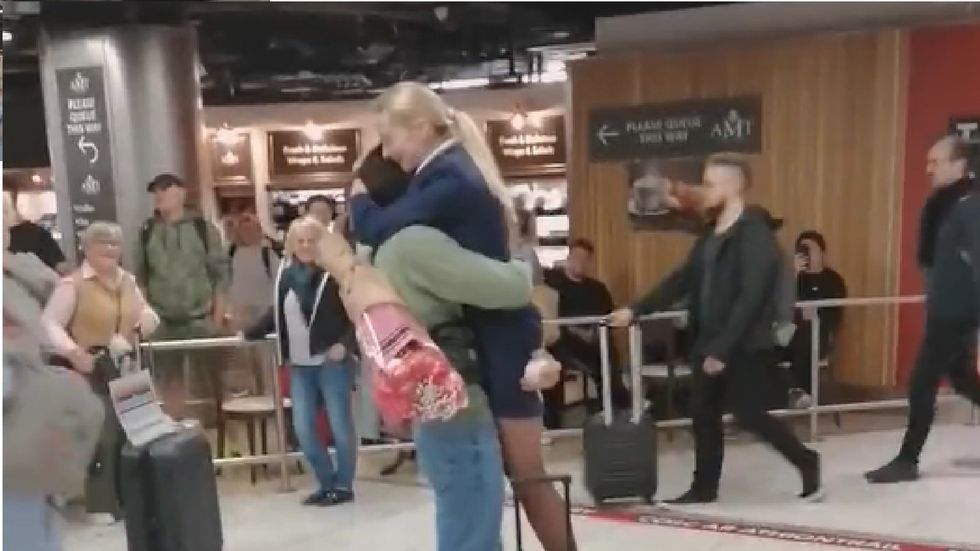 Crowd cheers as man proposes to flight attendant in Dublin Airport