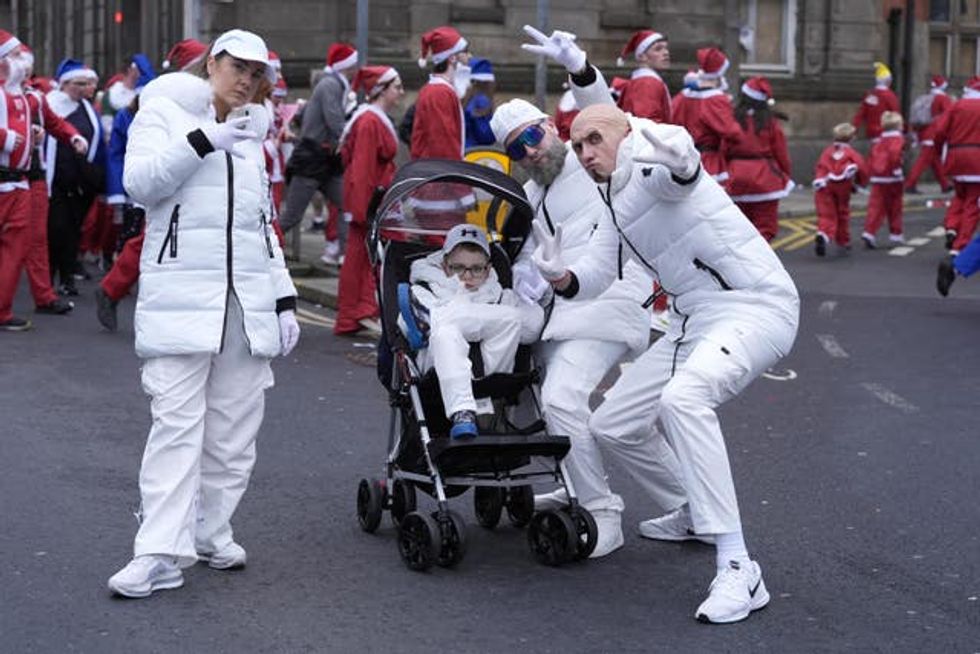 A group of four dressed in the white outfits of East 17