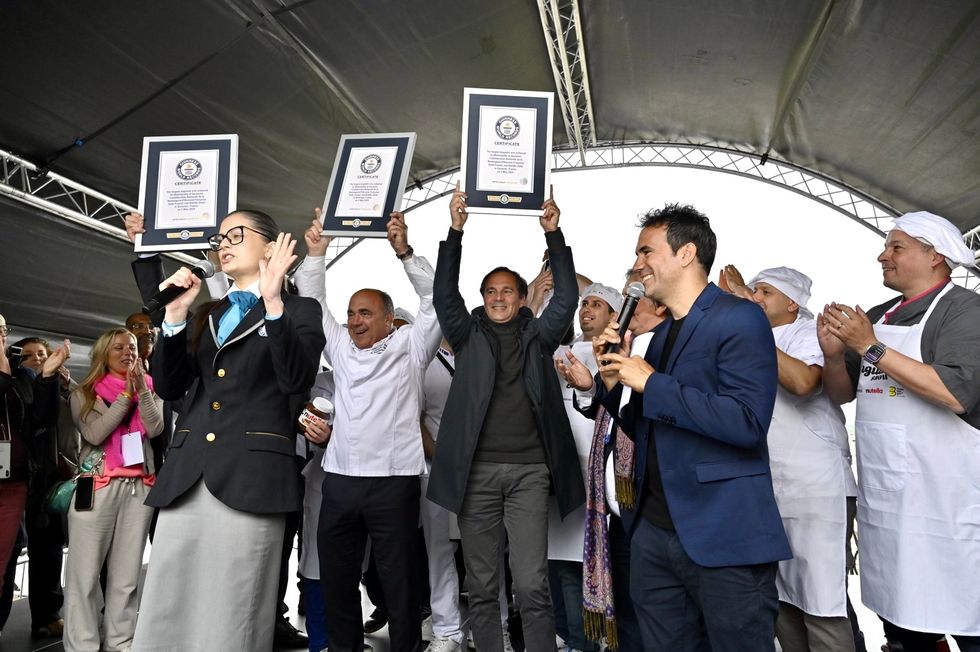 A group of people cheering with their Guinness World Record certificates
