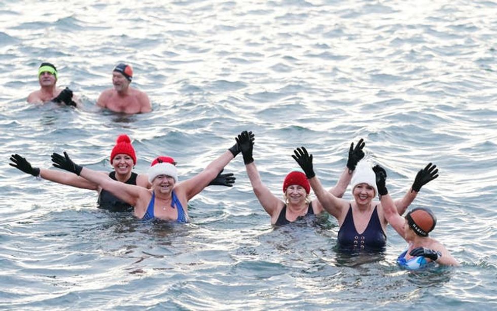 A group of people swimming in the sea