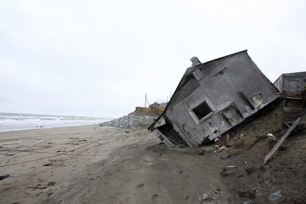 A home destroyed by beach erosion lies  in the the Alaskan village of Shishmaref