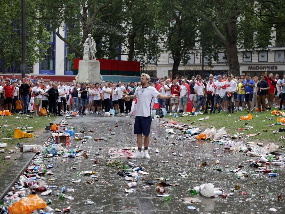 A lone England fan was pelted with bottles by a crowd in central London ahead of the Euro 2020 final