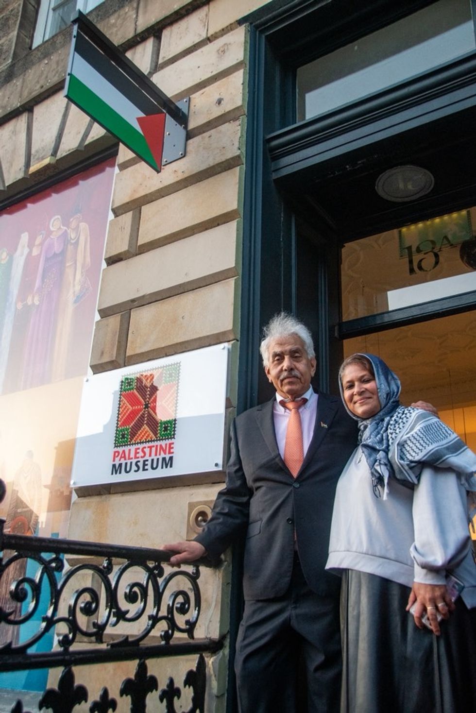 A man and a woman standing outside a gallery