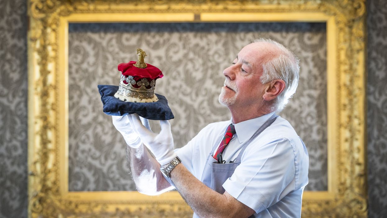 A man holding a coronet