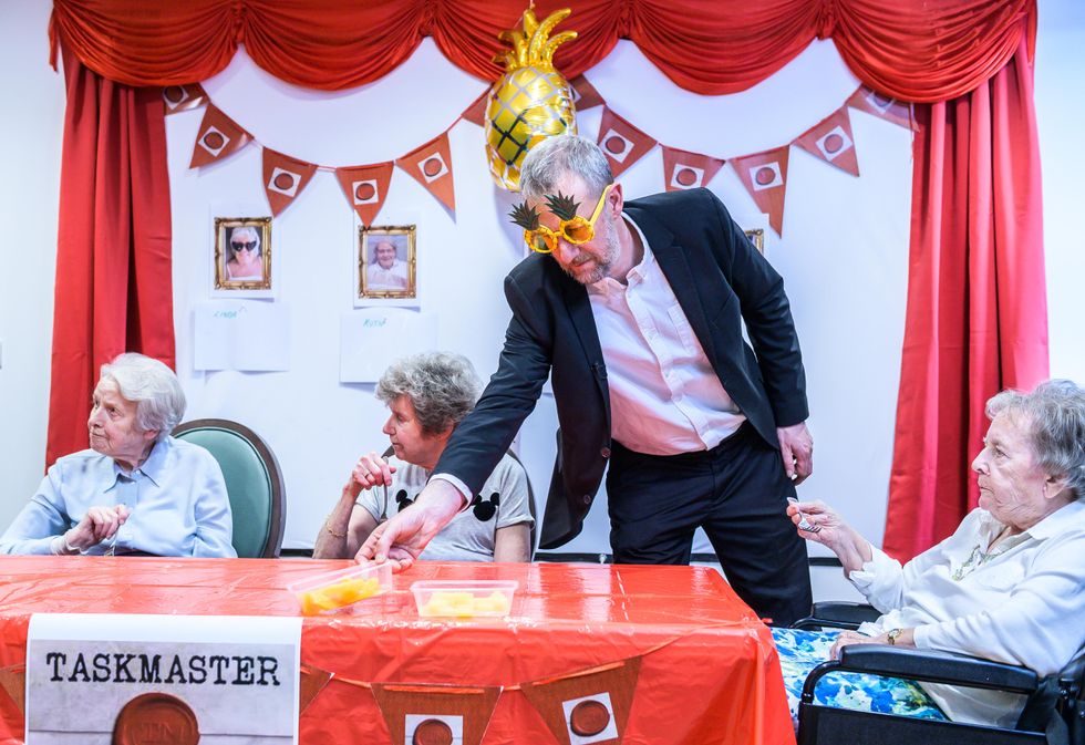 A man in fancy dress at a care home