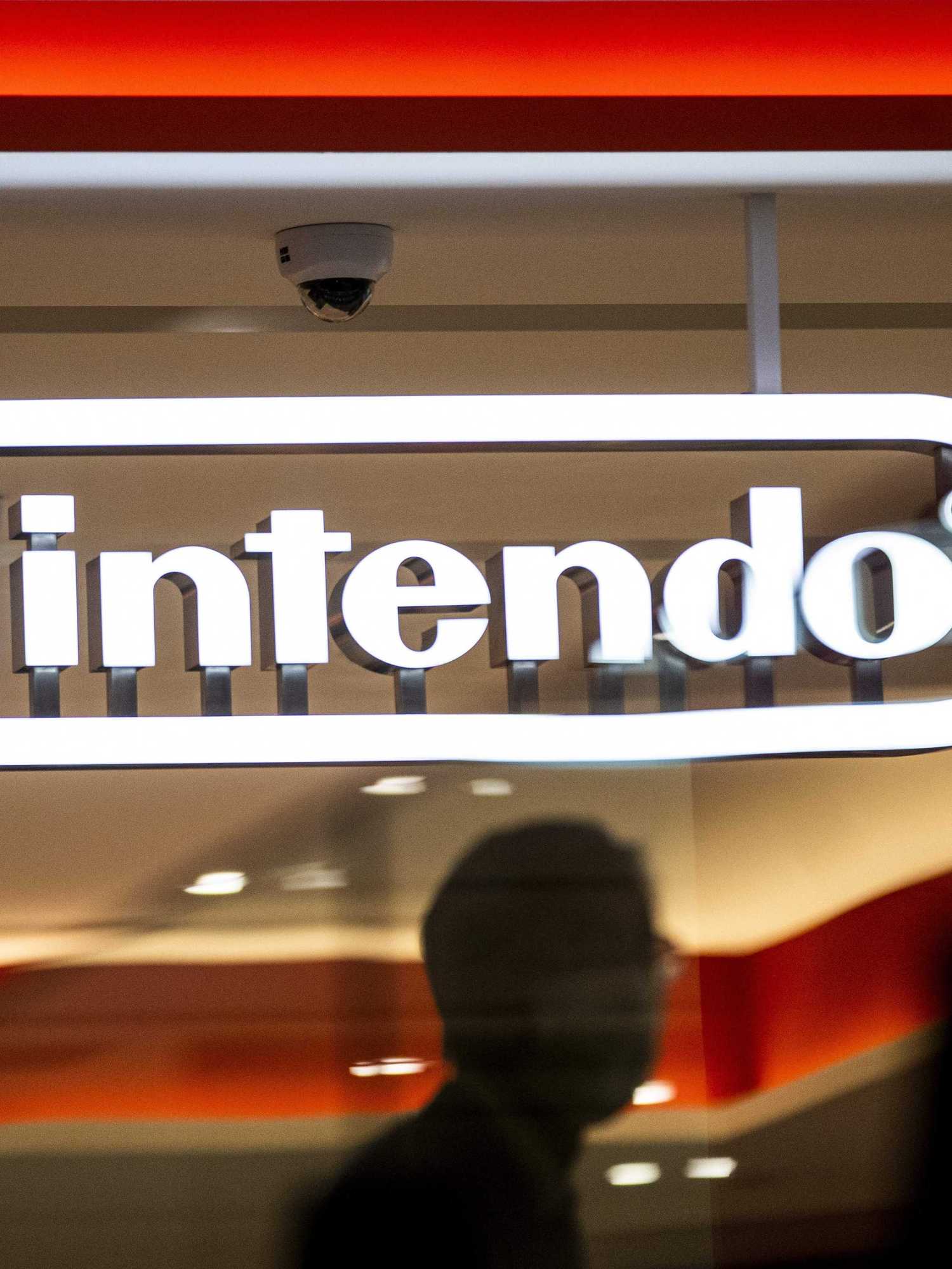 A man walks past a logo of Japan's Nintendo Co. at a Nintendo store in Tokyo on November 5, 2020