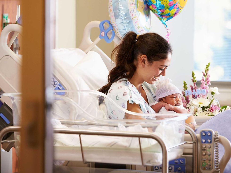 A mother with a newborn baby in maternity ward
