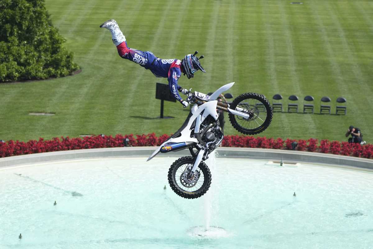 A motorcyclist performs a mid-air stunt over the south lawn of the White House.