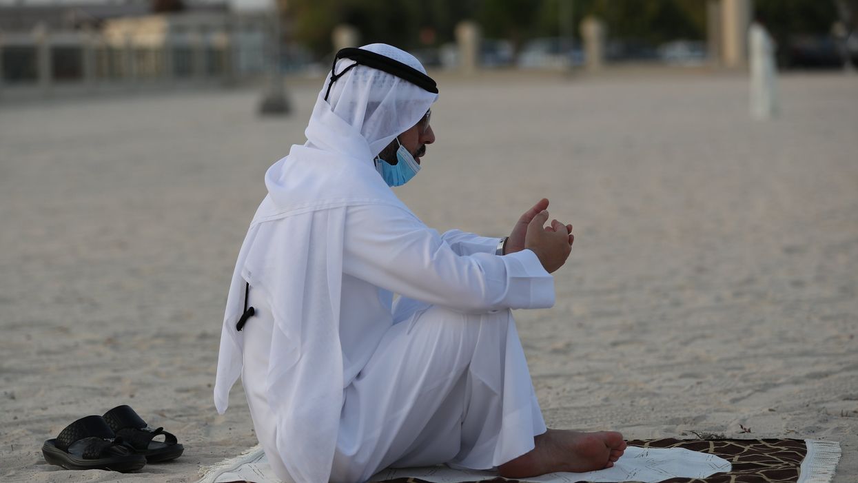 <p>A Muslim performs Eid Al Adha prayers in the Gulf emirate of Dubai, United Arab Emirates, 20 July 2021. </p>