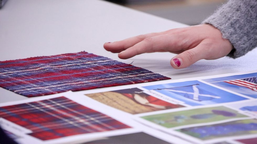 A number of tartan designs sit on a table
