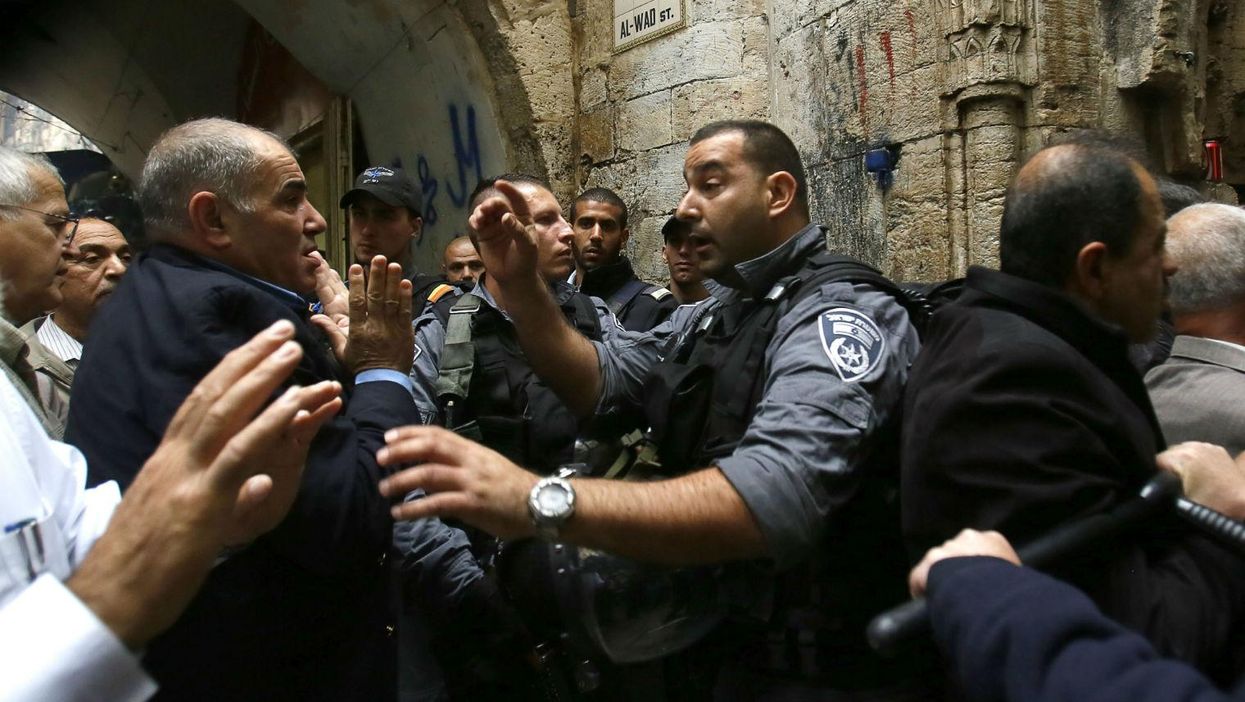A Palestinian man argues with Israeli anti-riot police deployed for the Friday prayer on October 31, 2014 in Jerusalem's Old City