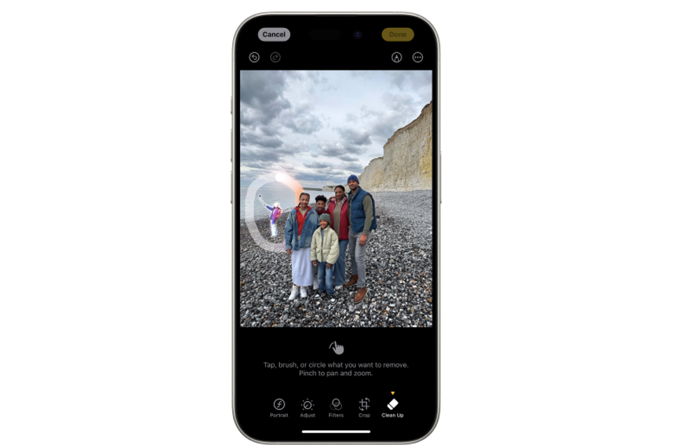 A person in the background of a photo is removed using a magic eraser tool