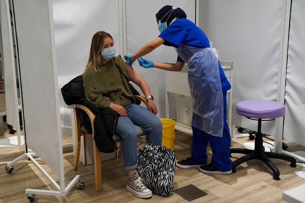A person receives a Covid-19 jab at a pop-up vaccination centre at Westfield Stratford City (Kirsty O\u2019Connor/PA)