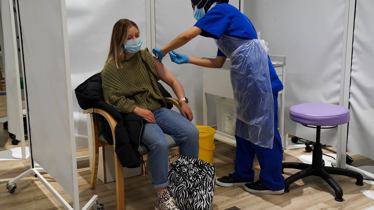 A person receives a Covid-19 jab at a pop-up vaccination centre at Westfield Stratford City (Kirsty O’Connor/PA)