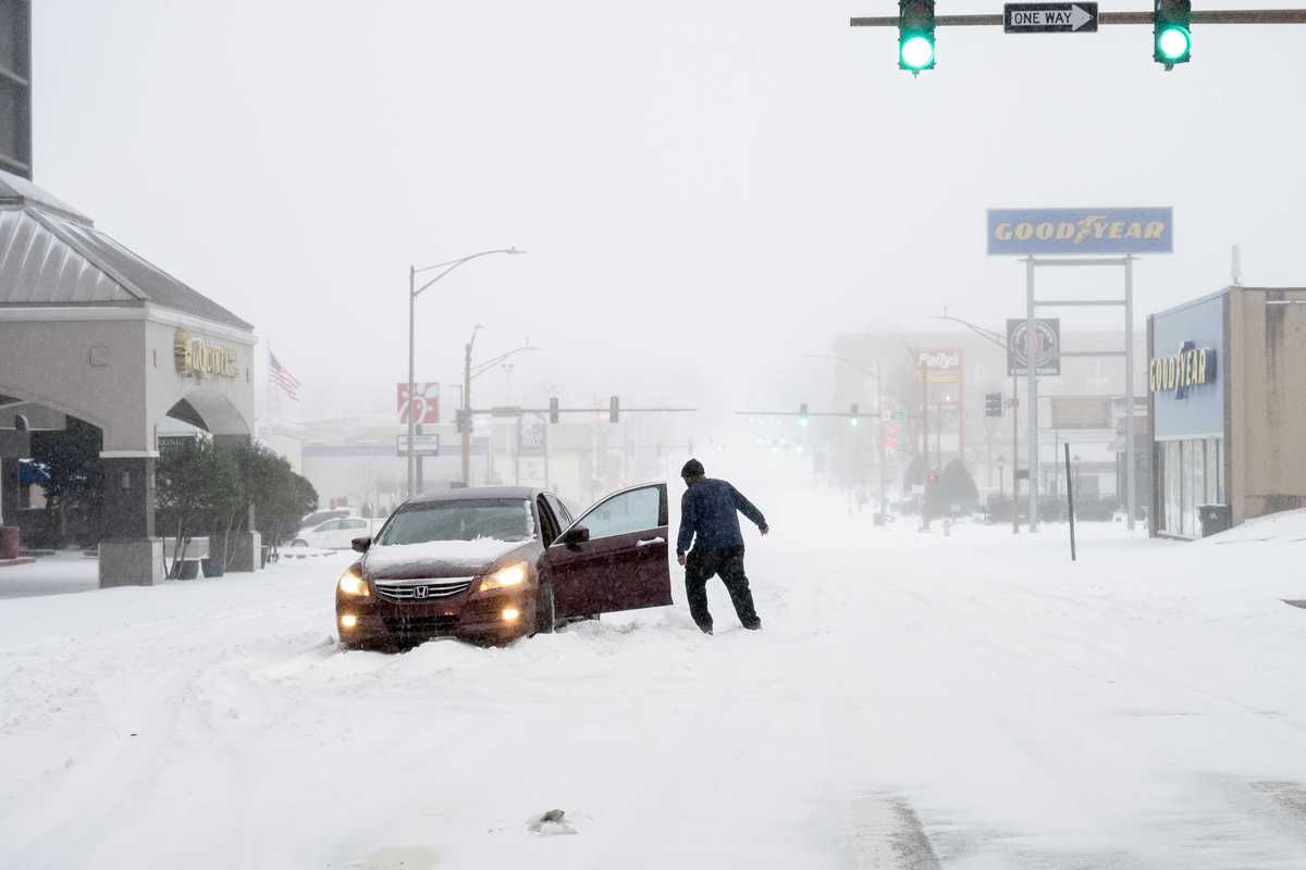 A person's car is stuck in the snow on January 24, 2026 in Little Rock, Arkansas. A massive winter storm is bringing freezing temperatures, ice, and snow to nearly 200 million Americans