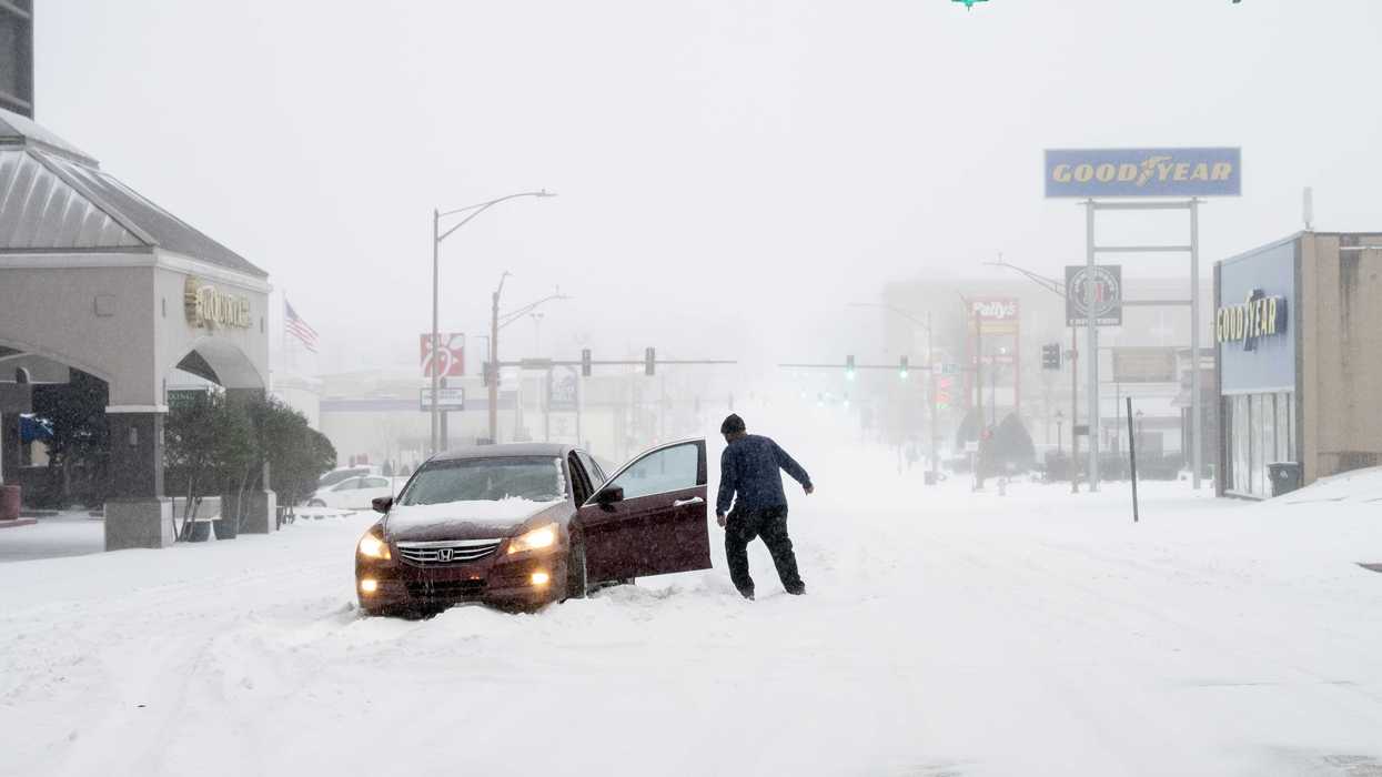 A person's car is stuck in the snow on January 24, 2026 in Little Rock, Arkansas. A massive winter storm is bringing freezing temperatures, ice, and snow to nearly 200 million Americans​