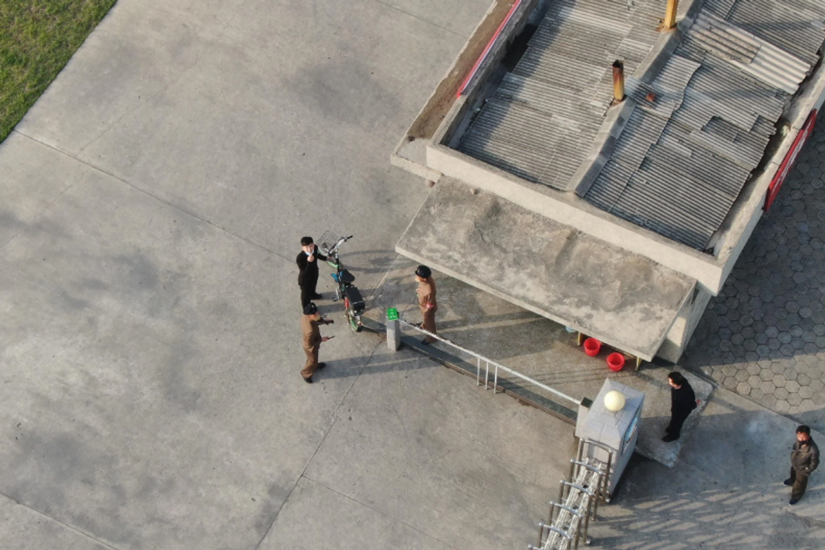 A photo apparently taken illegally by a drone in North Korea, showing people looking upwards towards the camera