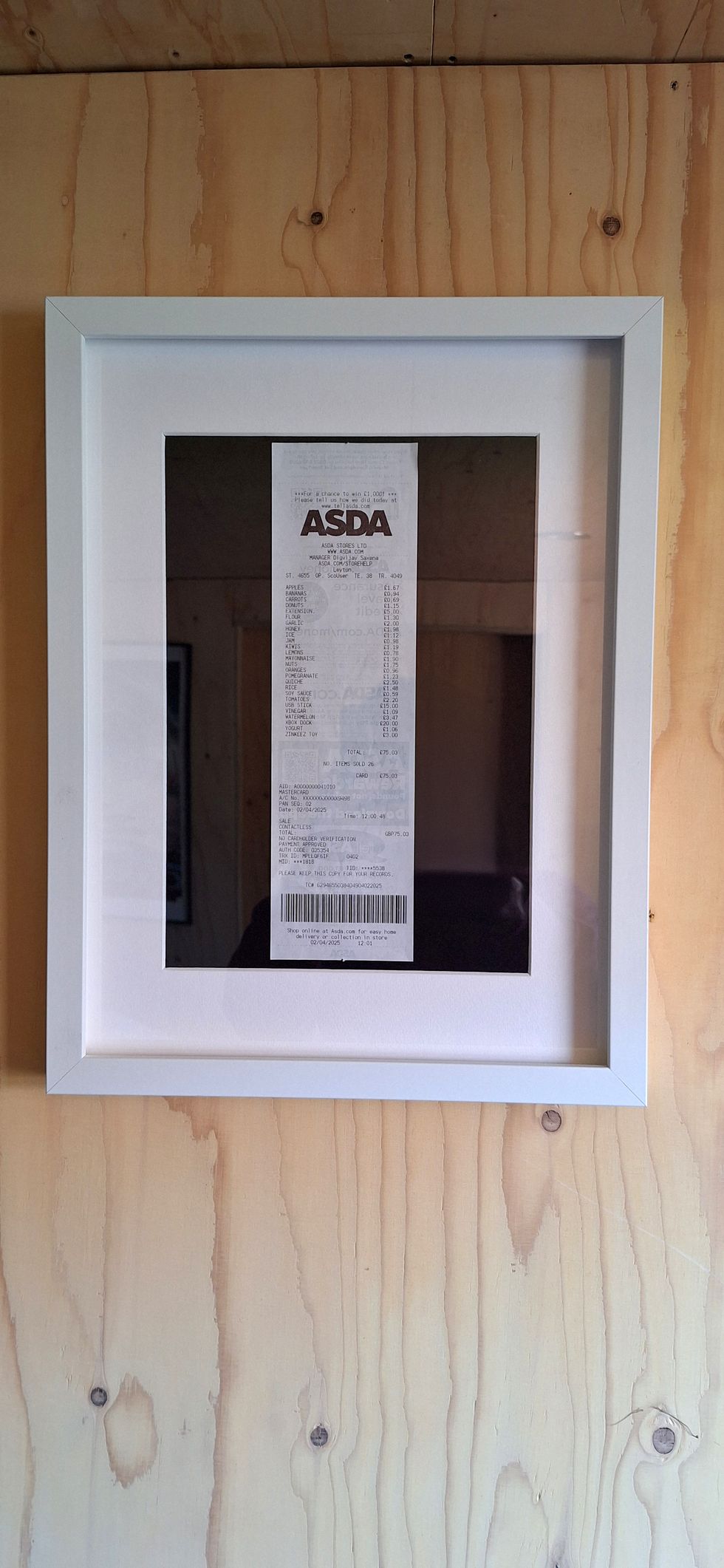 A picture frame containing the shopping receipt