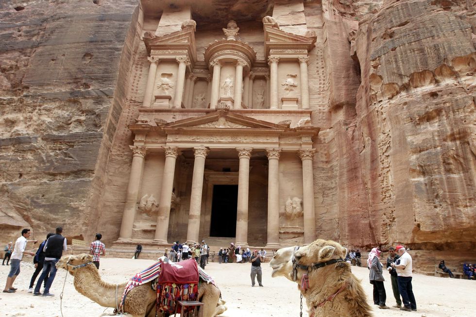 A picture taken on March 25, 2015 shows tourists walking in front of the Khazneh (Treasury) in Jordan's ancient city of Petra