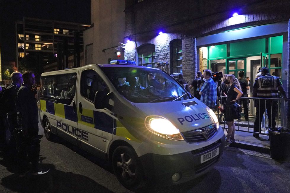 A police van outside the Egg nightclub in London as police talk to security