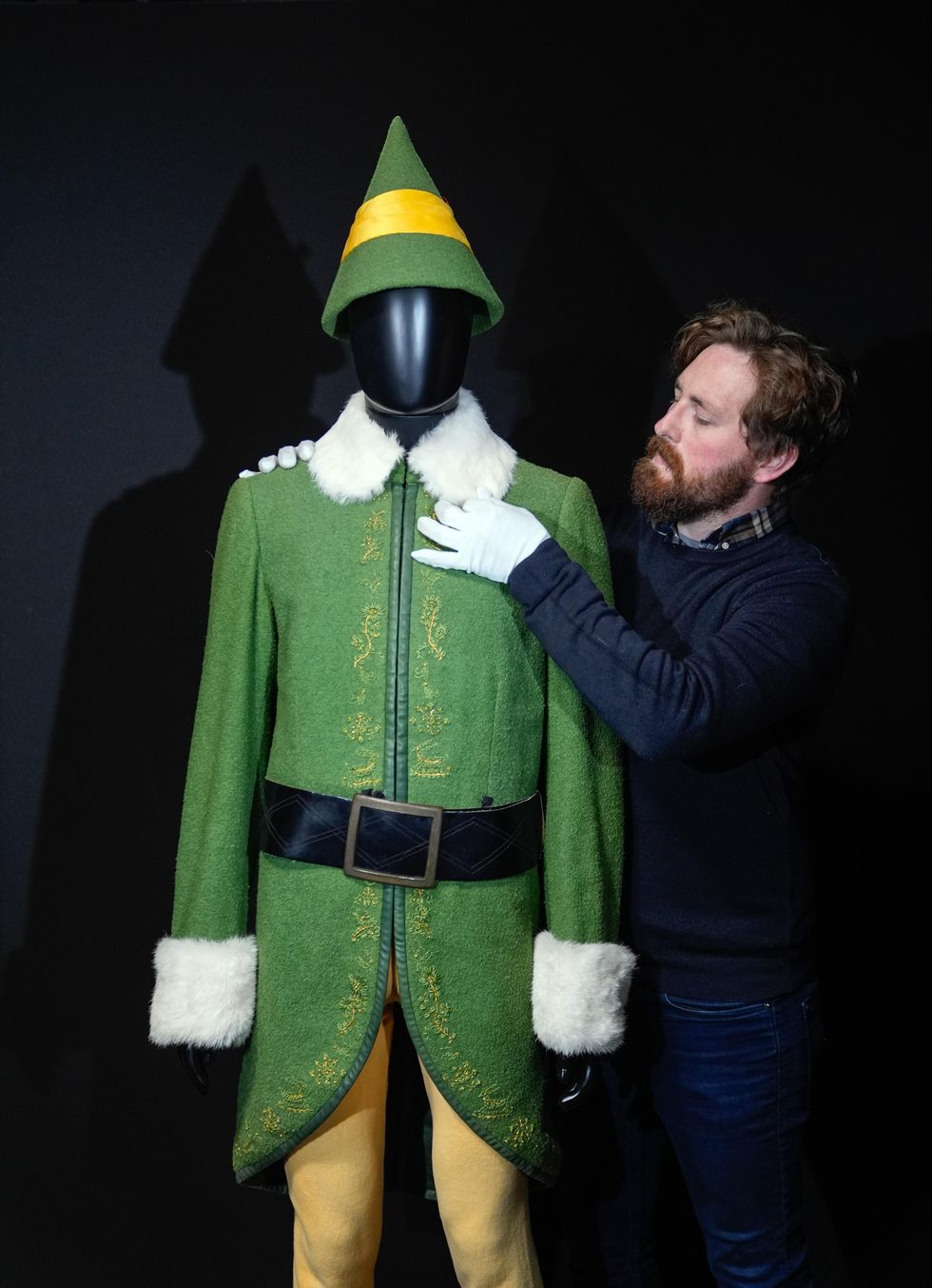 A Propstore employee adjusts Buddy's (Will Ferrell) screen-matched hero Elf costume