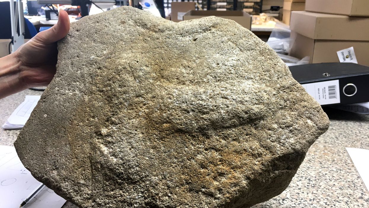 A rare Roman millstone with a phallus engraving was found during the A14 improvement project in Cambridgeshire. (Highways England/ PA)