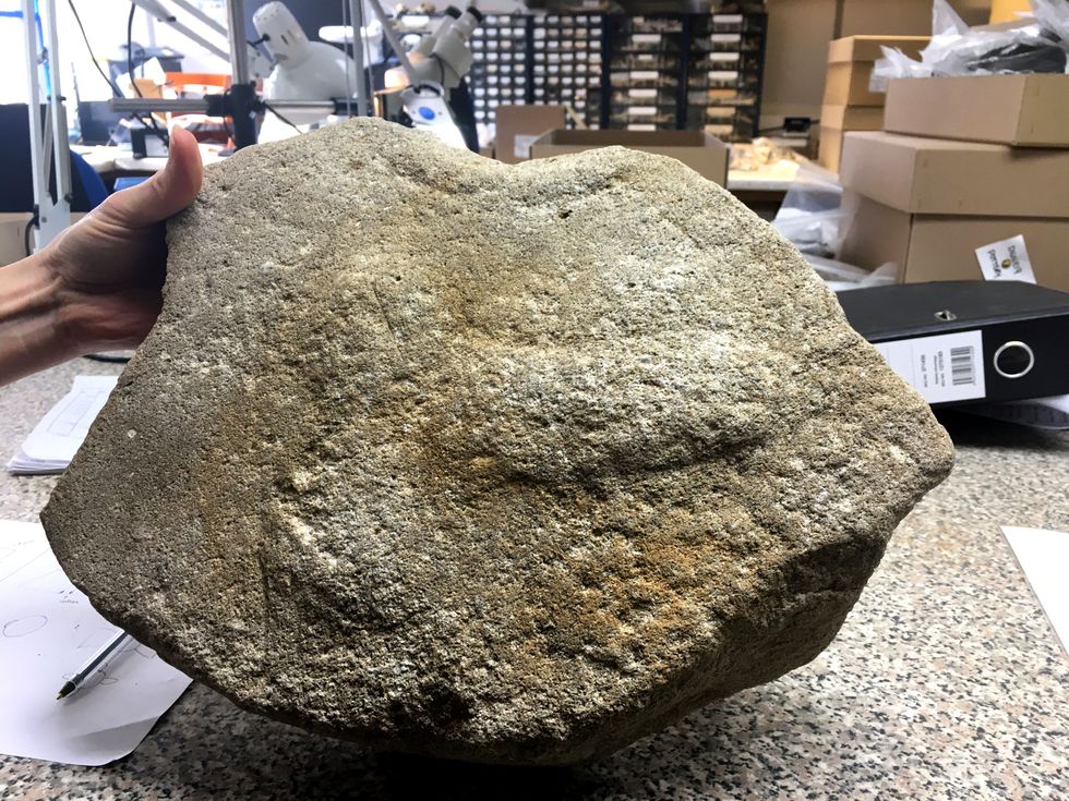 A rare Roman millstone with a phallus engraving was found during the A14 improvement project in Cambridgeshire. (Highways England/ PA)