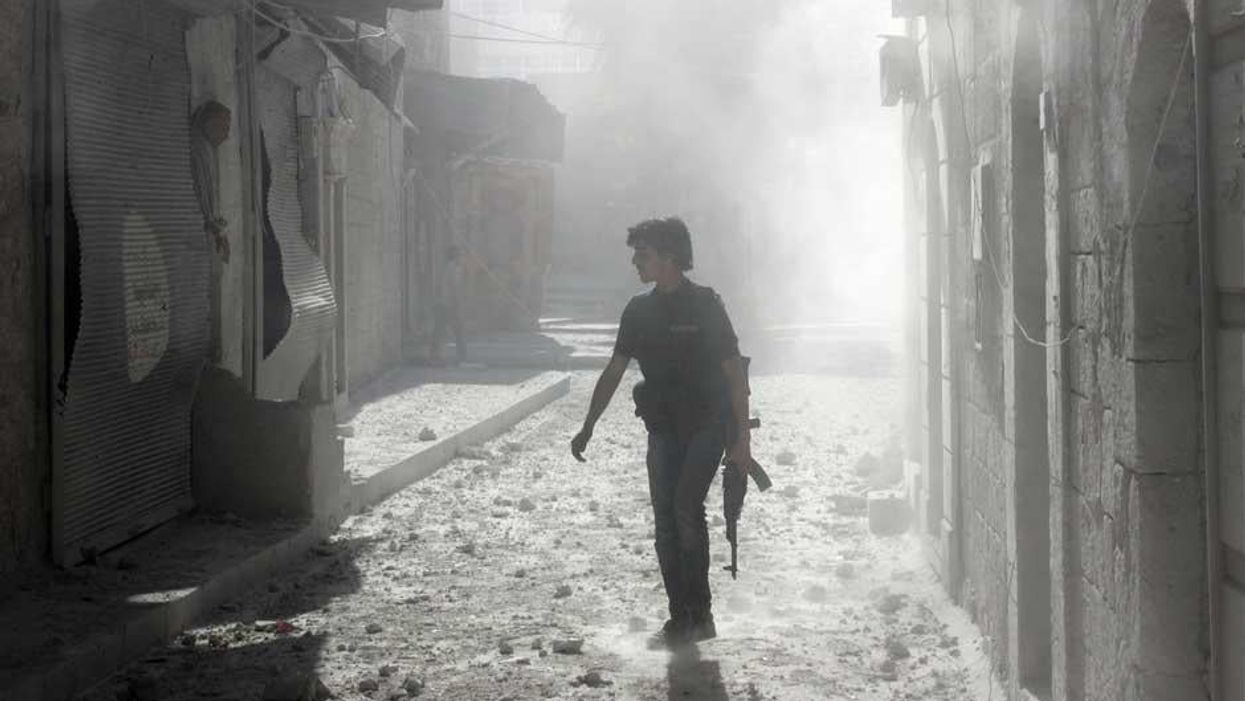 A rebel fighter on the streets of Aleppo in April