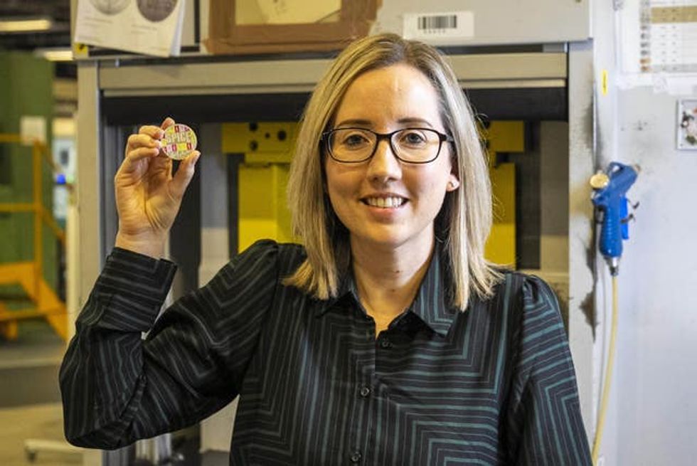 A Royal Mint Spice Girls coin being held up