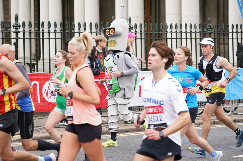 A runner dressed as Bender, the robot from Futurama, passes the Old Naval College (Jonathan Brady/PA)