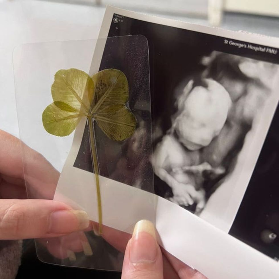 A scan photo of Arthur Ransom alongside a four leaf clover