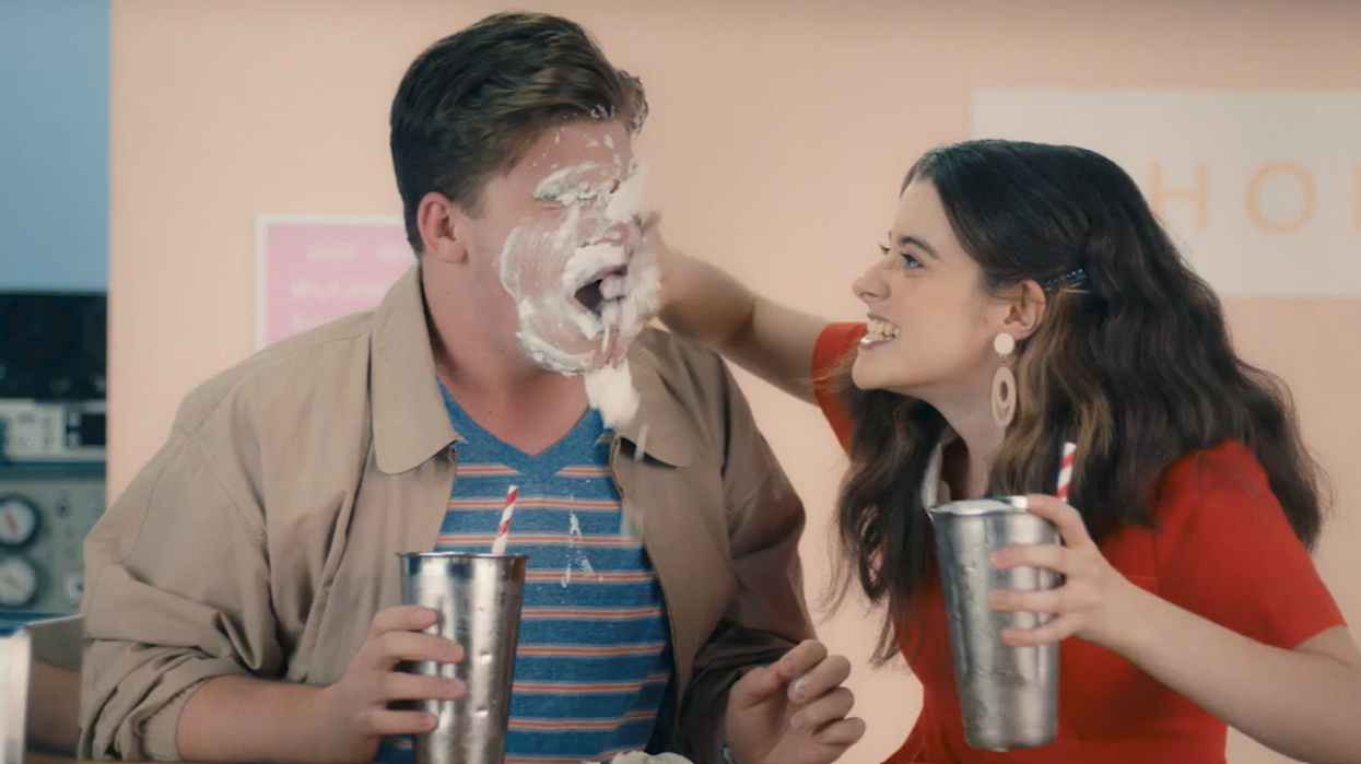 <p>A screenshot from the consent video shows a woman smearing milkshake on a man’s face.</p>