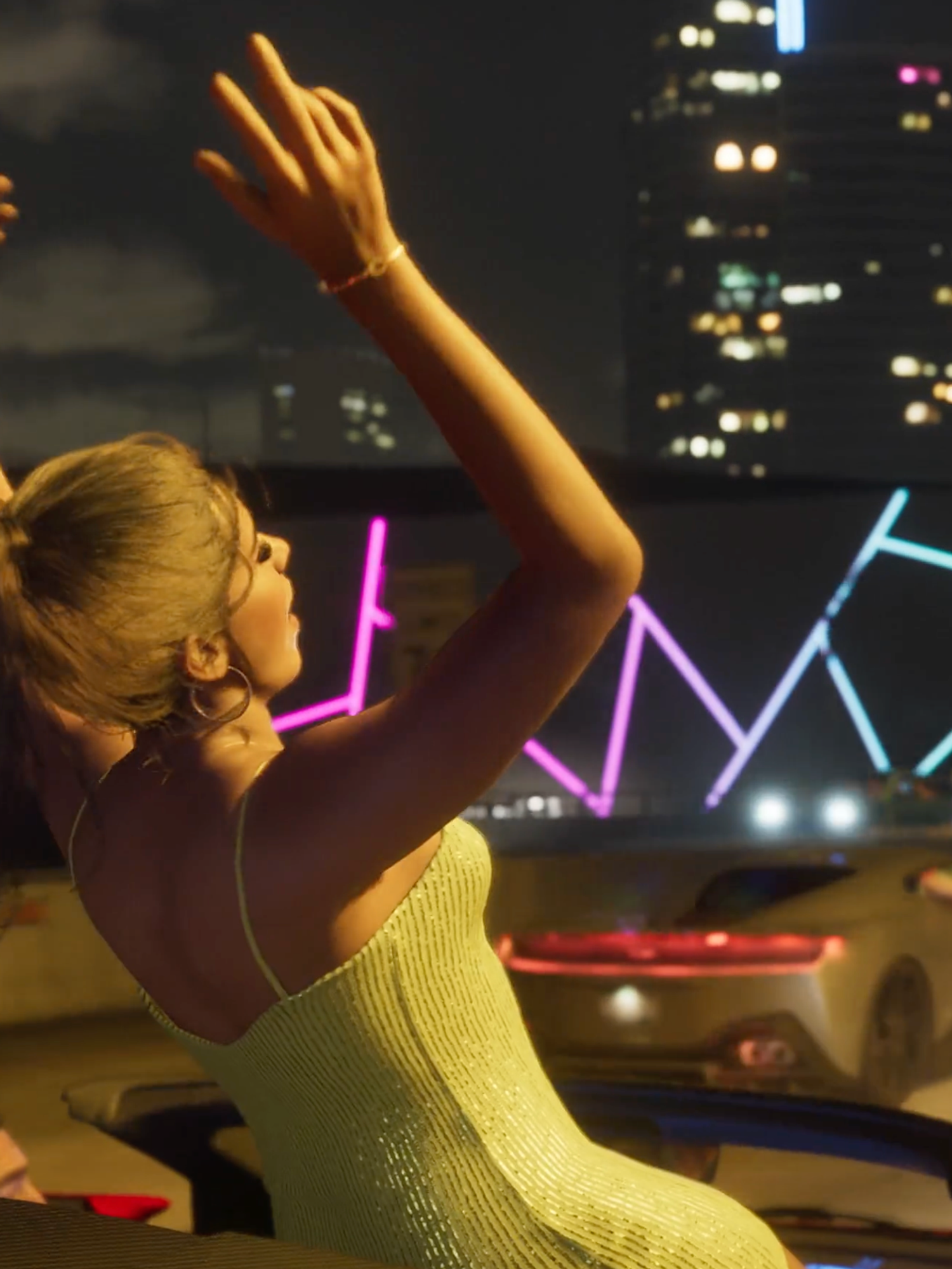 A screenshot of a woman out the top of a car celebrating