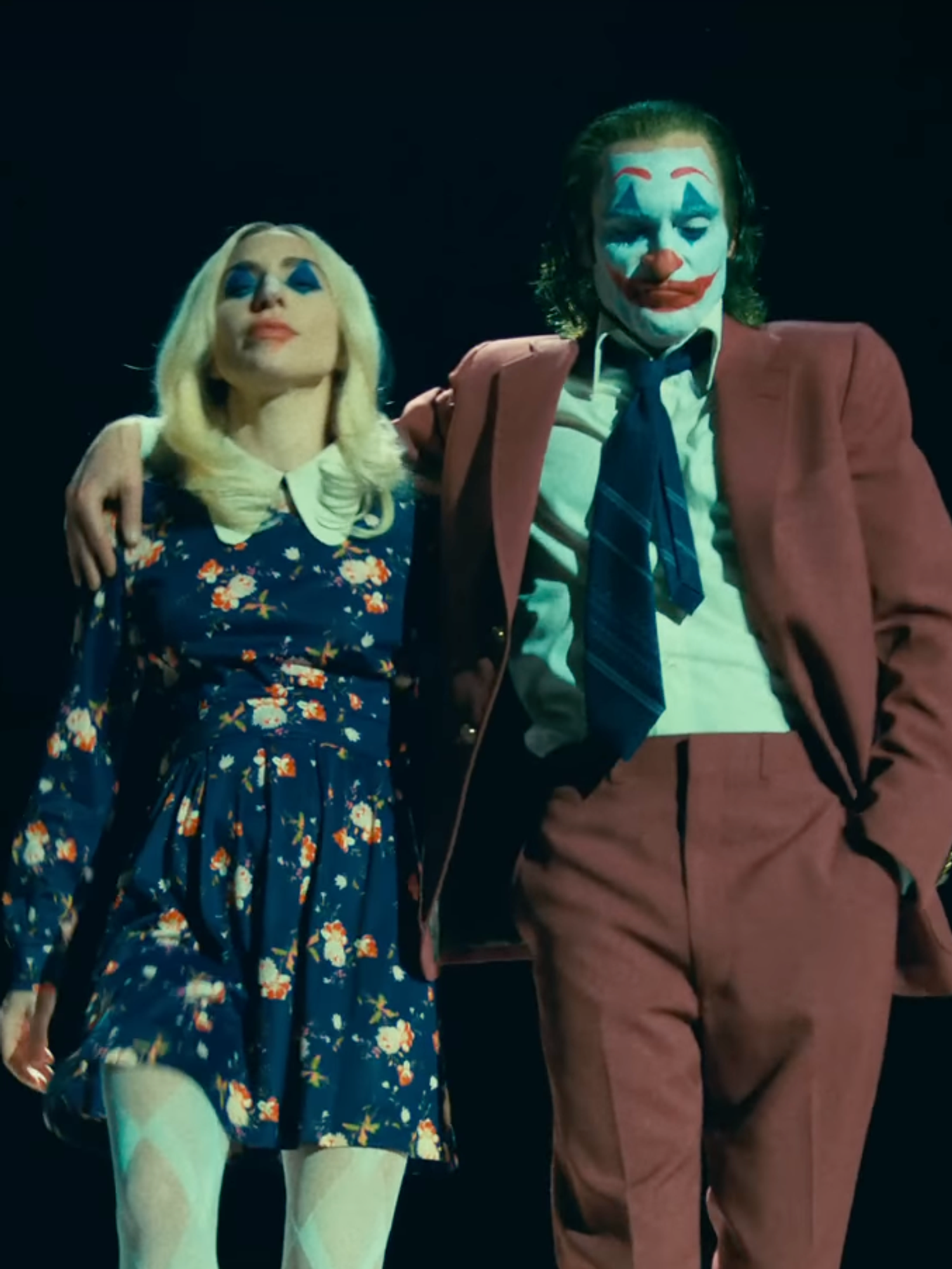 A screenshot of Lady Gaga as Harley Quinn and Joaquin Phoenix as Joker in the trailer for Joker Folie a Deux