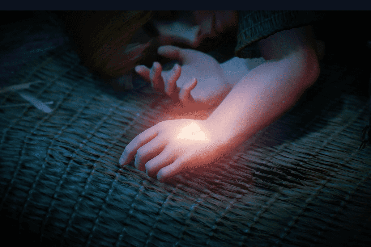 A screenshot of the Triforce mark shining on the back of a young Zelda's hand in The Legend of Zelda Ocarina of Time remake teaser trailer